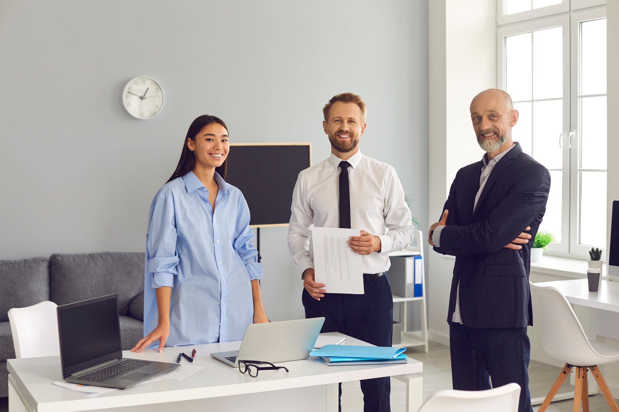 Happy Staff of Company Marketing Department Standing Together in Office Looking at Camera